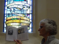 G15 Glennis Smith offers the stained glass William Guinness a look at the book  in Christ Church South Yarra